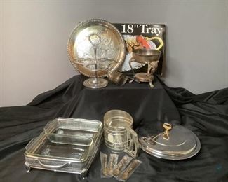Silver Plated Trays & More
One (1) 18" silver plated tray (in box), two (2) round silver plated serving trays, glass chafing dishes in silver color holder, flour sifter, four (4) mini brass colored spoons & more.