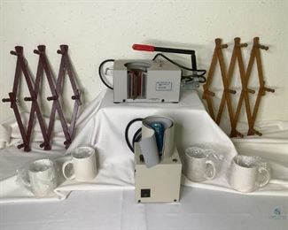 Mugs and Mug Press Machine
Great for designing your own mugs! Includes two expandable wooden mug wall racks, open partial case of new white mugs and two mug press machines. One machine is a Thermal Transfer Press by Hotonix. One is by RPL Supplies, Inc. Working condition unknown.
