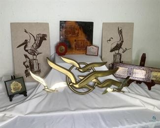 Sea Inspired Art
Two (2) pelican canvas prints, 20"Hx12"W, unarmed. Set of birds in light wall art made of plastic and metal, largest piece is 10"Hx28"W. Five (5) decoupage art pieces of ships with sails, largest piece is 11.5"x11.5"