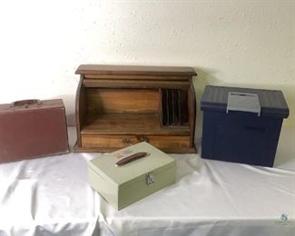 Desk Storage & Boxes
One (1) wooden desk organizer with roll top closure and one drawer H13" x W23" x D12". One (1) plastic file folder storage box. One (1) vintage box with clasp closure (inside has tag stating Philco). One (1) metal cash box H11" x W10" includes keys.