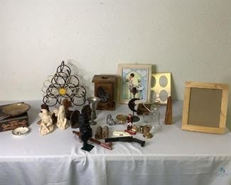 Miscellaneous Decoration
Large lot of miscellaneous decoration including metal wine rack with sunflower motif, Jack Daniels tin, fairy sculptures, wooden horses on stands, votive holders & a variety of candle holders, picture frames, glass bird, knickknacks and more! See photos for sampling of items.