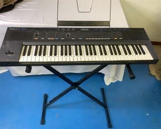 Roland Keyboard
Roland E-20 Synthesizer keyboard with stand. Includes instruction booklet and music books. No power cord found.