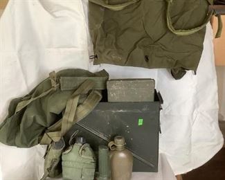 Military Gear
Various items of military gear including: metal ammo box, two (2) duffel bags, (3) canteens, flashlight, first aid kit.