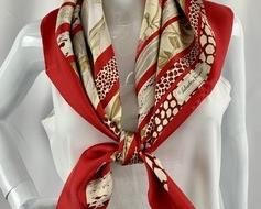 A beautiful 33" square silk scarf by designer Salvatore Ferragamo, featuring hibiscus flowers in red tones, calla lillies in white, in a series of botanical stripes. Made in Italy, 100% silk. The luxurious scarf is in excellent condition and is folded in its original box and designer tissue.