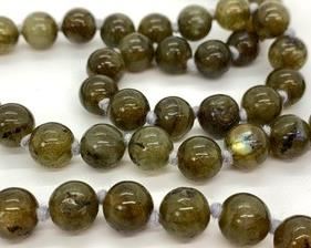 This 32" necklace is made of smooth olive green spectrolite 8 mm beads, polished and shiny. They are strung on a thicker grey thread and knotted between every bead. It is a continuous necklace with no clasp. Excellent condition.