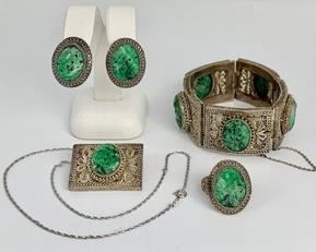 Truly a vintage set, made by artisans in China circa 1946. Carved jade ovals decorate these pieces, set in very fine and ornate silver plate filigree. Pieces are in very good condition for age.
