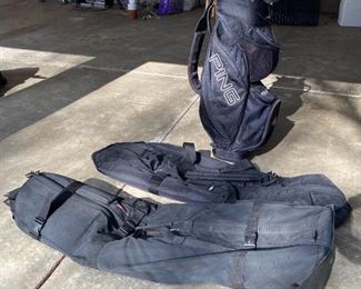 Ping Golf Bag with a Variety of Putters and Two Travel Bags