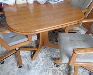 OAK TABLE WITH ARM CHAIRS ON WHEELS