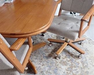 OAK TABLE WITH ARM CHAIRS ON WHEELS