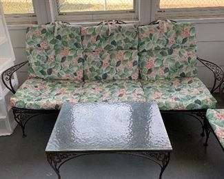 Sofa with cushions and coffee table match the chairs and end table.
