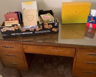 Desk with glass top.  New stationery and cards are also for sale. 