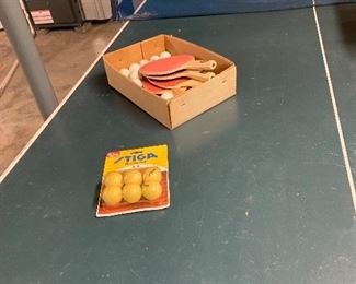 Ping Pong table with balls and paddles.  Folds up and rolls for storage