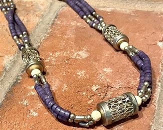 $34; silver cylinders with lavender colored, wooden beads. 22" end to end. 