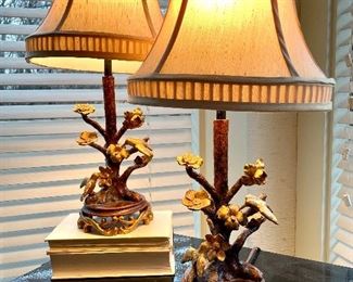 $220; Pair of lamps with feeding hummingbirds in black and gold; unique detail and finials; 12”d x 24”h