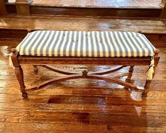 $400; 2-seat, distressed pine bench with rush seat above 4 legs and a double Y-stretcher plus custom silk, striped cushion (has some small holes); 42”w x 17”d x 19”h