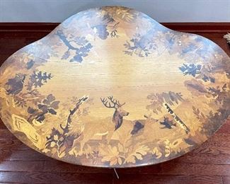 view of table from the top showing all the different animals and birds and colors of inlaid woods