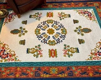 $800; knotted rust, green and teal area rug; fringe on short sides; 5.5’ x 8’