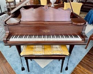 beautifully cared-for grand piano and bench with custom cushion; many carved details