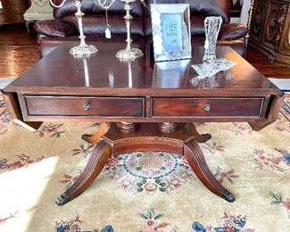 $450; Drexel Heritage “Covington Park” collection antique drop-leaf, 2-drawer coffee table; 43”w x 30”d x 25”h. Minor condition issue on base. 