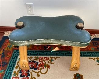 $200; vintage Egyptian camel saddle footstool; 22”w x 13”d x 15”h