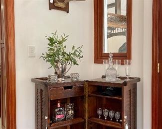 $200; vintage bar cabinet on casters to open; louvered  front doors that lock; one drawer and five shelves; 28”w x 18”d x 37”h