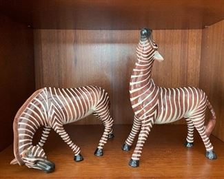 $60; pair of hand-painted, ceramic zebras; each approx 9”w x 4”d x 10”h