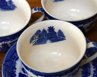 blue and white teacups and saucers