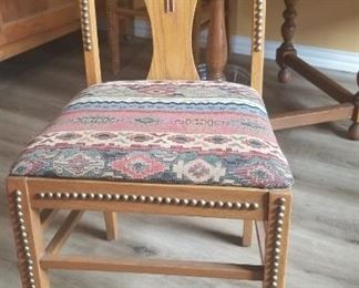 Four chairs to match the dining table. Western motif