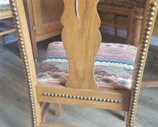 Dining chair matches table. Western motif on back