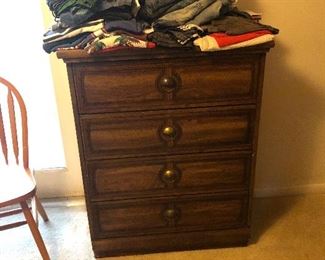 Dresser and stack of clothes