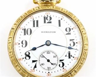 A Hamilton 992 Model Railroad watch.  16 size, 21 j, Adj Temp & 5 pos, DR, DMK, GJS, SW, LS, Recased Elgin GF with hinged cuvette, OF, Porcelain DSD with Arabic numerals marked "Hamilton".  Serial #2376162.  Minor wear, small dent in rear cover, winds, sets and running when cataloged.  ESTIMATE $200-300