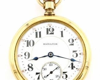 A Hamilton Model 992 Railroad watch.  16 size, 21 j, Swing Out movement, Adj 5 pos, DR, DMK, GJS, SW, LS, Keystone GF, OF, Porcelain DSD with Arabic numerals marked "Hamilton".  Serial #1743954.  Minor wear, shallow dent in rear cover, winds, sets and running when cataloged.  ESTIMATE $200-300