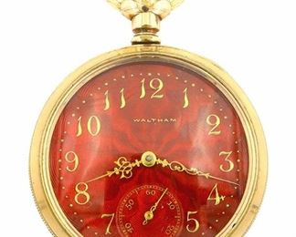 A Waltham Model 1888 Pocket watch with fancy Guilloche dial.  16 size, 7 j, SW, LS, Keystone GF, OF, Fancy Burgundy Guilloche enamel SSD with Gold Arabic numerals and filigree hands marked "Waltham".  Serial #8262522.  Some wear and denting on rear cover, dial hairline at 4:00, winds, and running when cataloged.  ESTIMATE $200-300