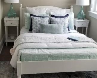 Full size bed & bedding; artwork; nightstands; rug; table lamps