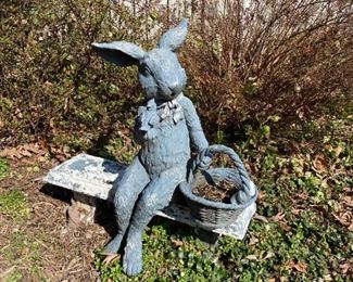 Rabbit sitting on bench.