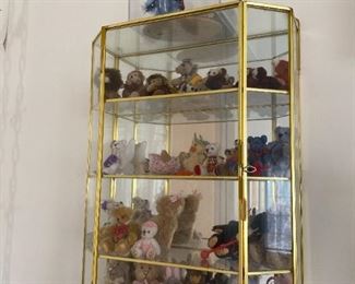 Glass case with miniature bears and rabbits.