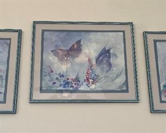 Framed butterfly prints.