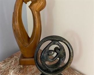 Carved man & woman kissing.