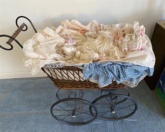 Vintage baby carriage with porcelain doll.