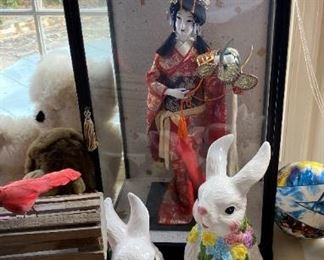 Bunnies and Asian doll in case.