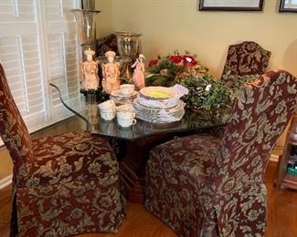 beveled glass table with wood base and upholstered chairs