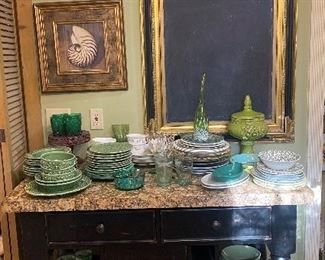Marble top island with assorted green glassware and china