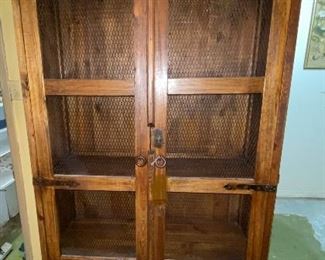 Tall double door cabinet with mesh inserts in doors
