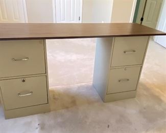 This makeshift desk (2-filing cabinets and a desktop) are located upstairs. Please notify us if you are interested in purchasing as upstairs will be closed off. 