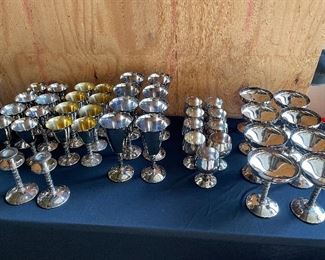 Silver sets, silver chalices and barware, candleholders