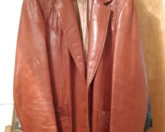 Stetson 44 Long leather jacket hangs on the bedroom door. Turn left as you enter to go up the stairs. This bedroom is the first on the left.