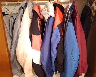 Winter wear hanging in the closet of first bedroom on the left.