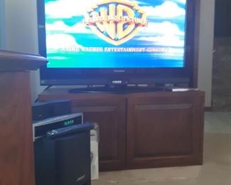 Panasonic TV (Forgive me please. I keep forgetting to measure it.) and the Bose DVD system. Living room, checkout room on the right as you enter.