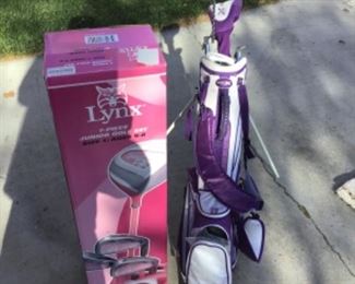 Two sets of youth golf clubs.