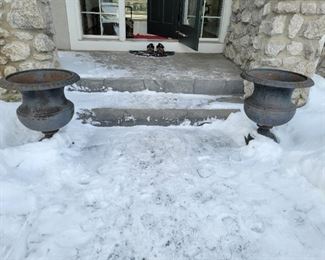 A pair of Cast Iron Urns.